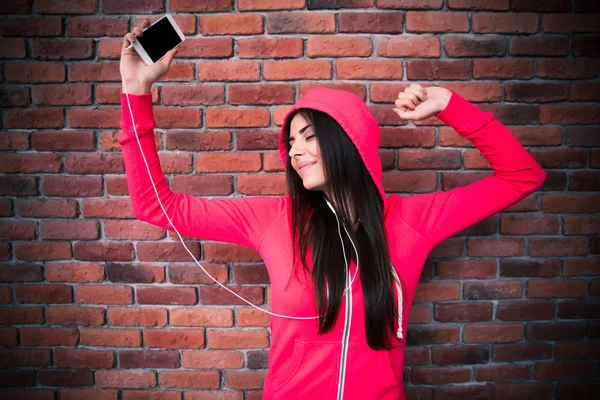 Happy woman listening music and dancing in headphones — Stock Photo, Image