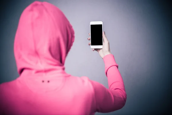 Back view portrait of a woman holding smartphone — Stock Photo, Image