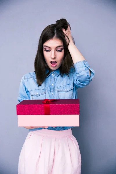 Surprised woman holding gift — Stock Photo, Image