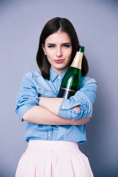 Beautiful cute woman holding bottle of champagne — Stock Photo, Image