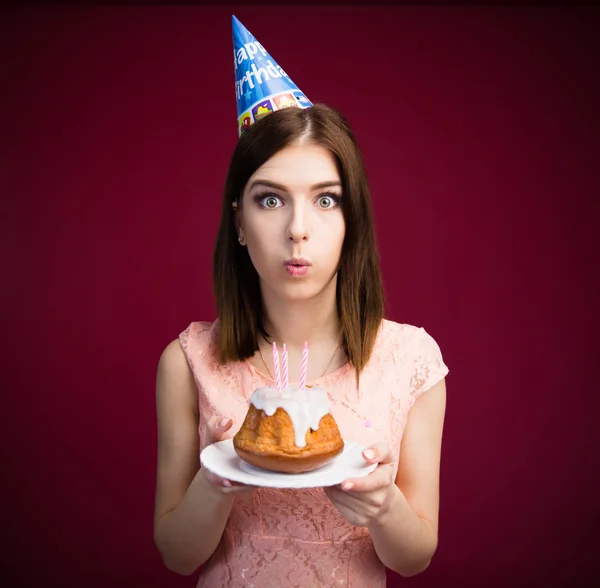Young woman blowing candles on her cake — Stock Photo, Image