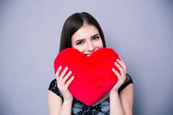 Happy beautiful woman holding red heart — Stock Photo, Image
