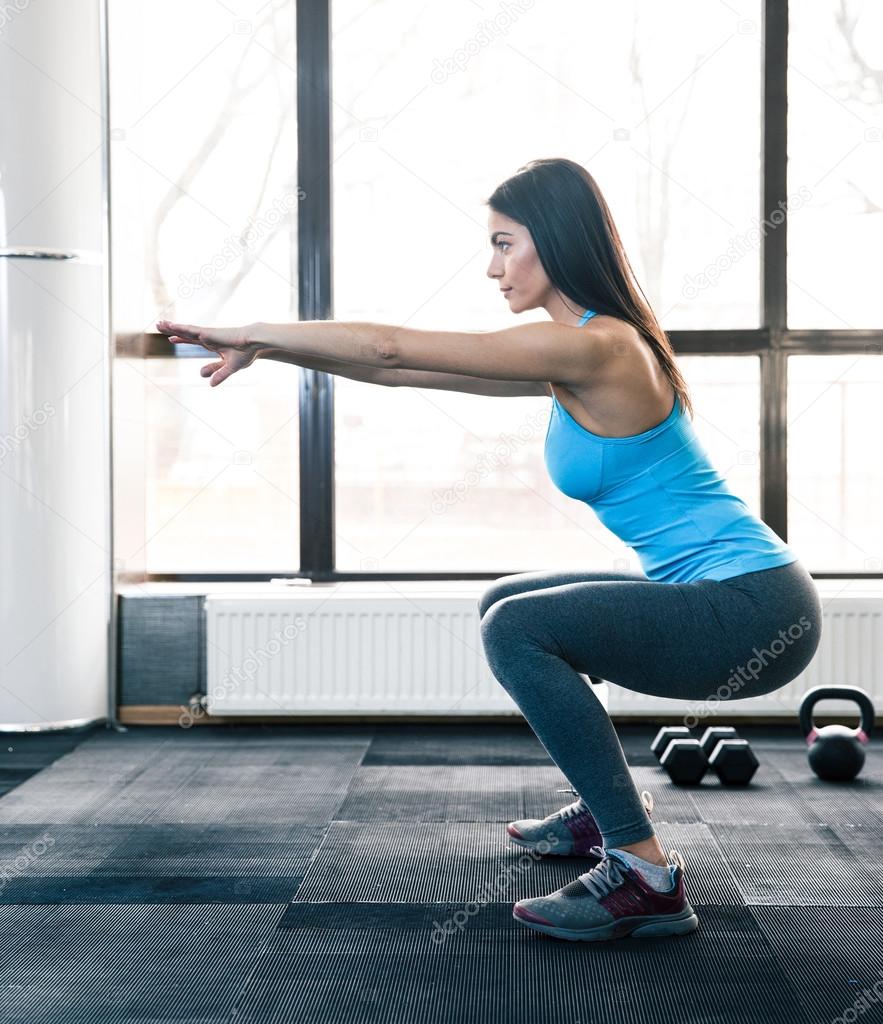 Young woman doing squats