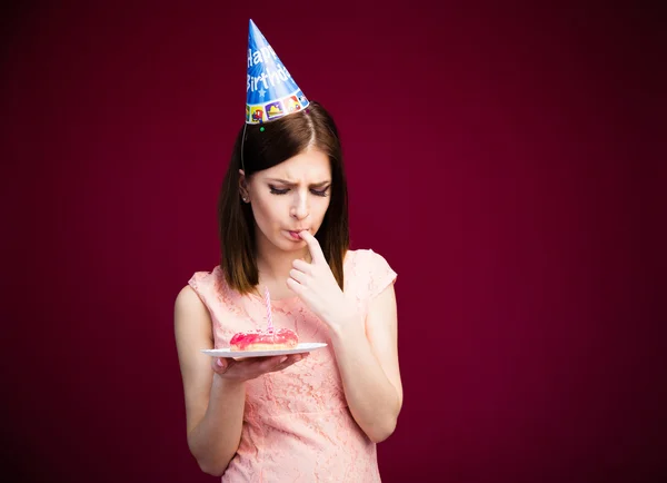 Young cute woman holding donut with candle — Stock Photo, Image