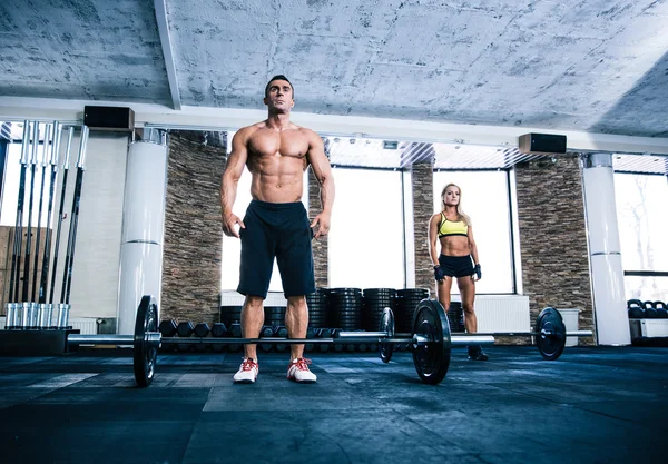 Fit man and woman workout at gym — Stock Photo, Image