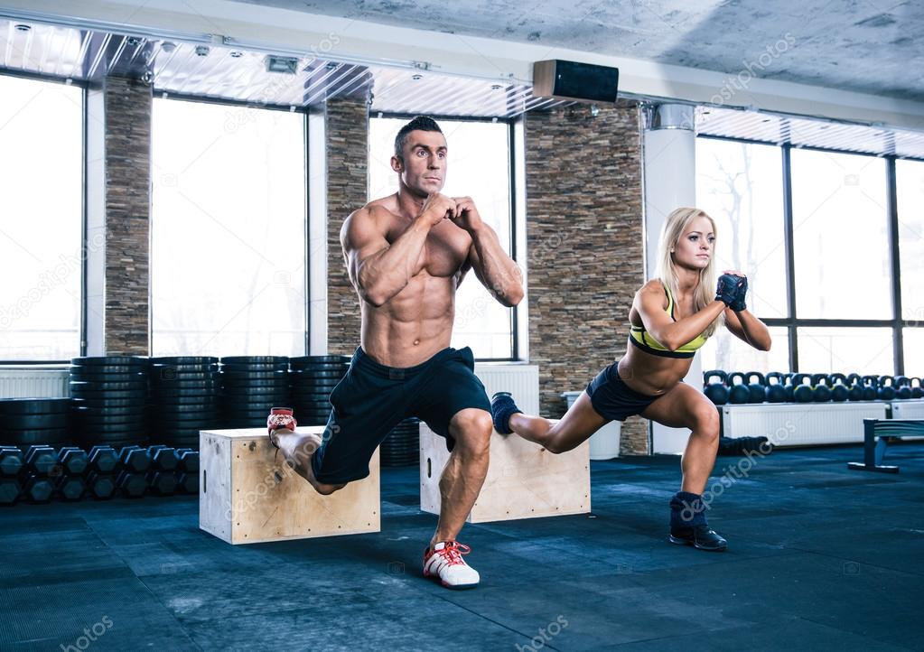 Woman and man working out at gym 