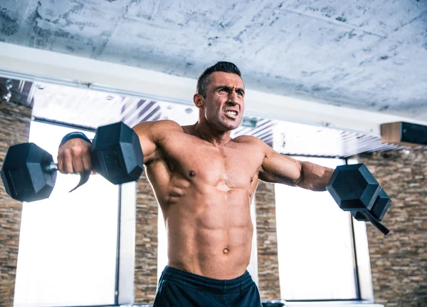 Muscular man workout with dumbbells — Stock Photo, Image