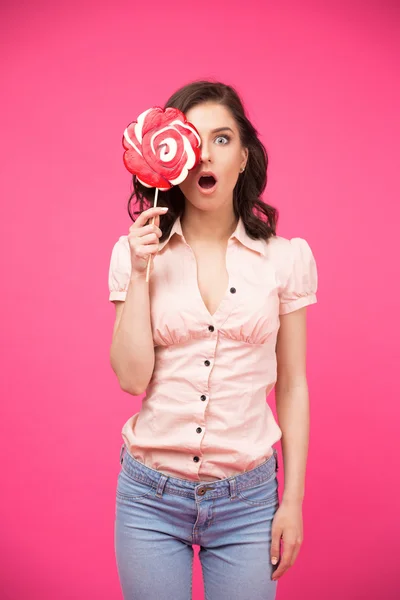 Woman covering her eye with lollipop — Stock Photo, Image