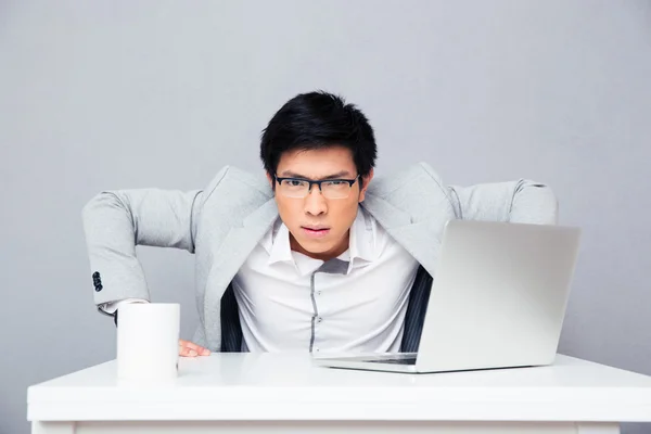 Serious businessman sitting at the table — Stock Photo, Image