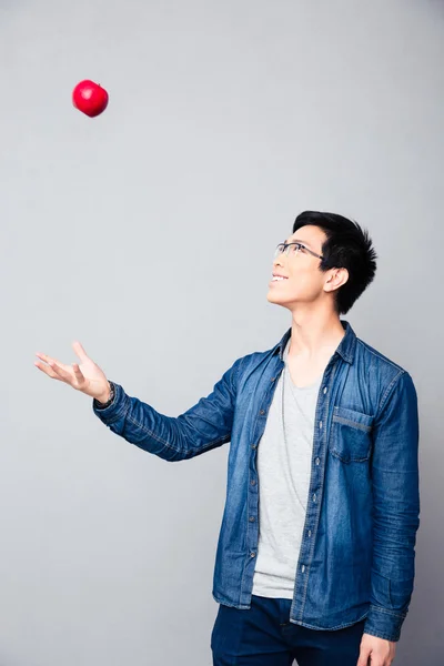 Happy young asian man with red apple — Stock Photo, Image