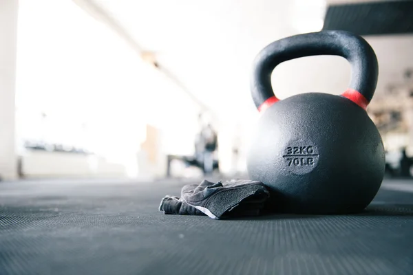 Kettle ball and sports gloves — Stock Photo, Image