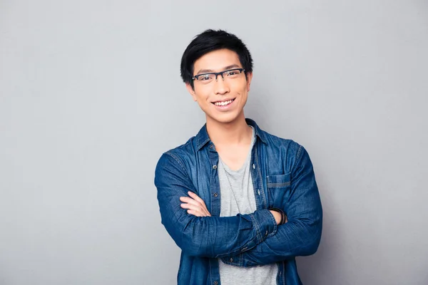 Portrait of a happy asian man with arms folded Stock Photo