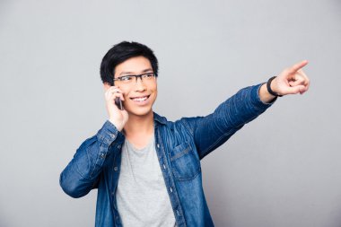 Telefonda konuşurken mutlu Asyalı adam 