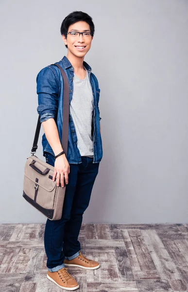 Happy young asian man standing in jeans wear — Stock Photo, Image