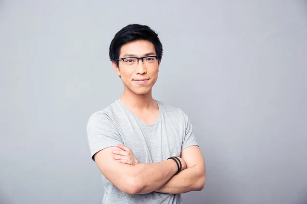 Portrait of a smiling asian man with hands crossed — Stock Photo, Image