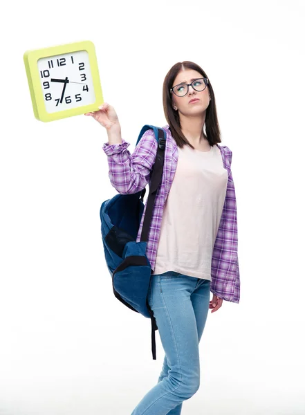 Sad female student looking at big clock — Stock Photo, Image