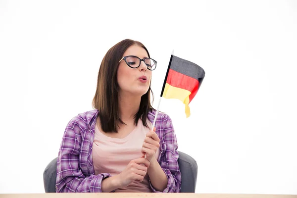 Young woman blowing on the German flag — Stock Photo, Image