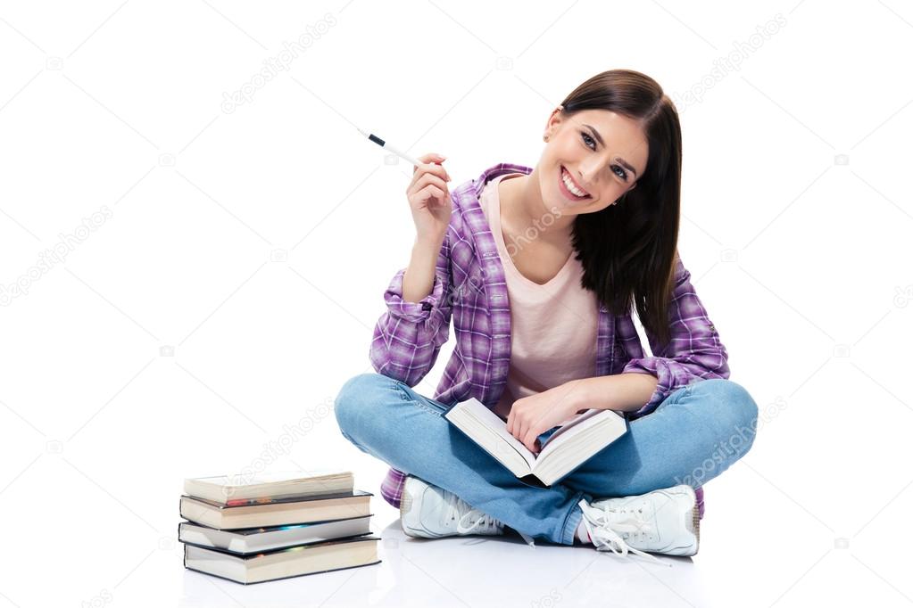 Smiling woman sitting on the floor with books