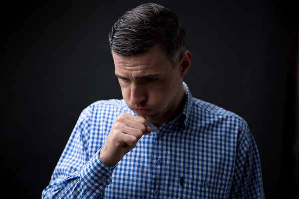 Portrait of a man coughing 