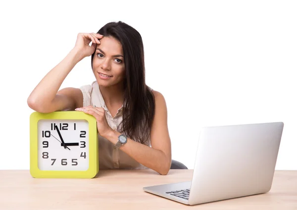 Businesswoman sitting at the table with laptop and clock — Stock Photo, Image