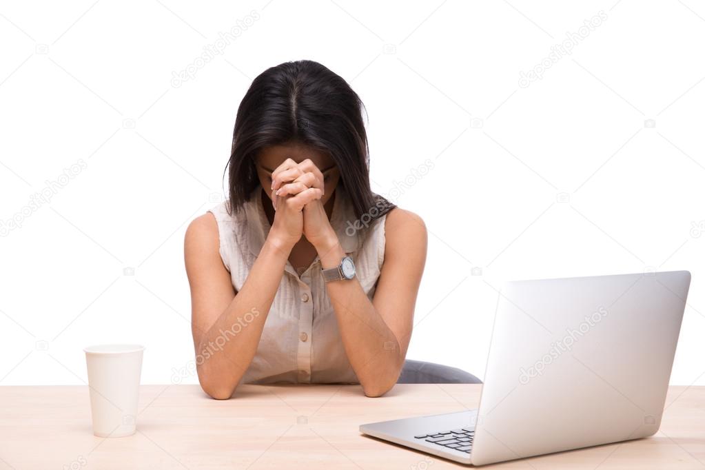 Tired businesswoman sitting at the table with laptop