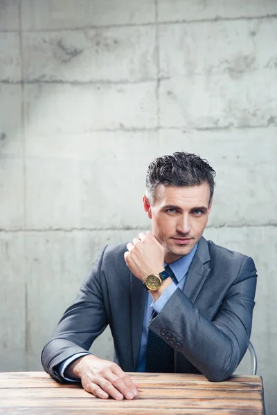 Bonito homem de negócios sentado à mesa — Fotografia de Stock