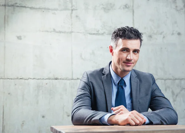 Happy businessman sitting at the table — Stock Photo, Image