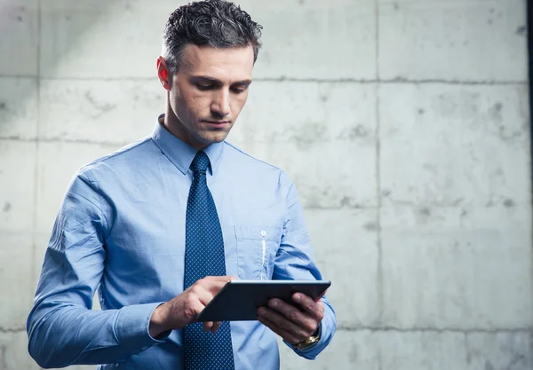 Serious businessman using tablet computer — Stock Photo, Image