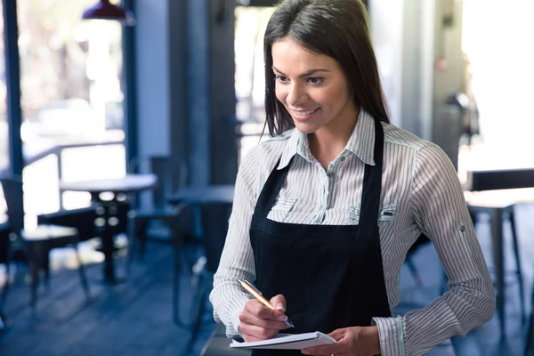 Smiling beautiful female waiter in apron — Stock Photo, Image