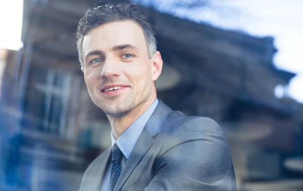 Portrait of a smiling businessman in cafe — Stock Photo, Image