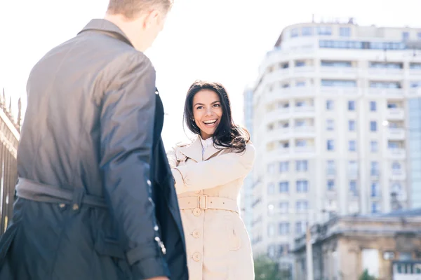 Happy woman flirting with man outdoors — Stock Photo, Image