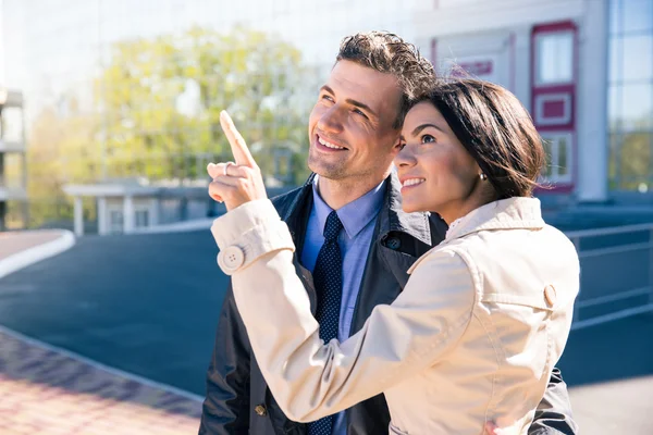 Happy woman pointing to something to her husband — Stock Photo, Image