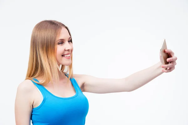 Smiling young woman making photo on smartphone — Stock Photo, Image