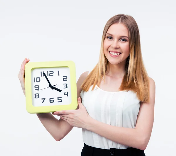 Smiling businesswoman holding big clock — Stock Photo, Image