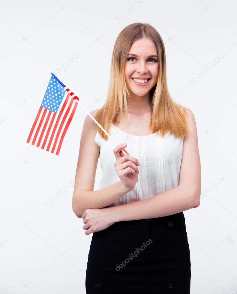 Happy young businesswoman standing with US flag