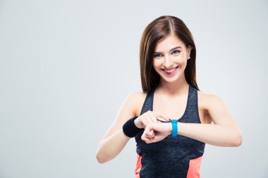 Smiling woman using activity tracker clipart