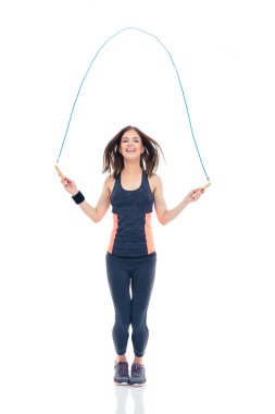 Cheerful woman doing exercises with jumping rope clipart