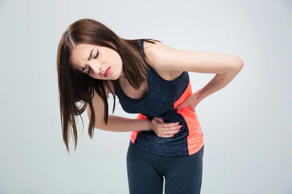 Fitness woman having pain in stomach — Stock Photo, Image