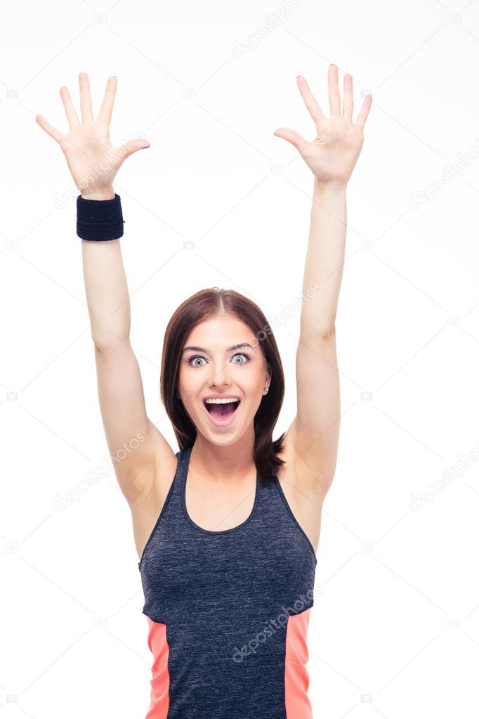 Laughing fitness woman standing with raised hands up