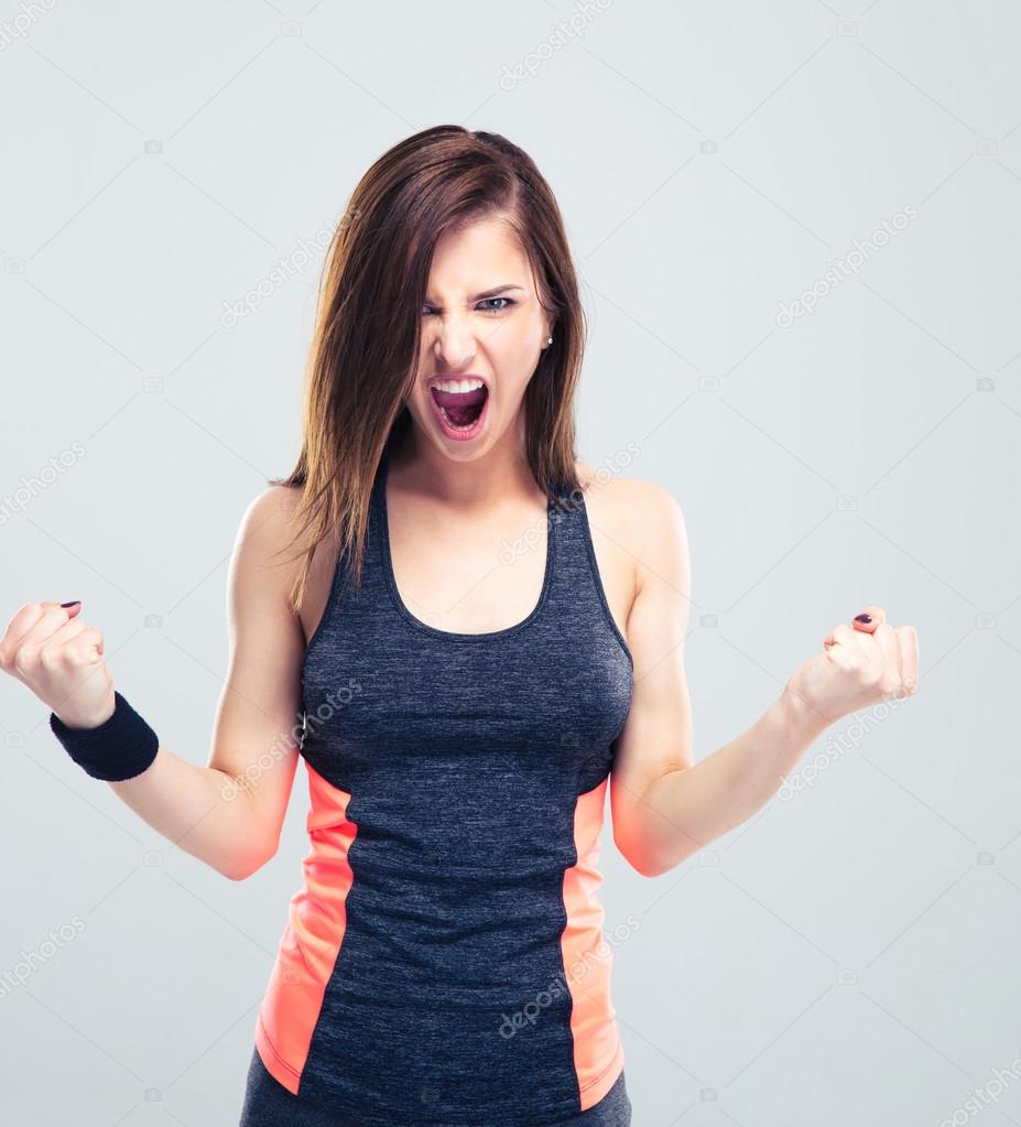 Angry young fitness woman screaming