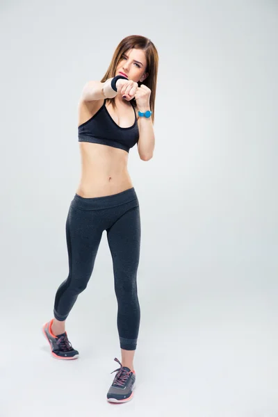 Fit young woman punching towards camera — Stock Photo, Image