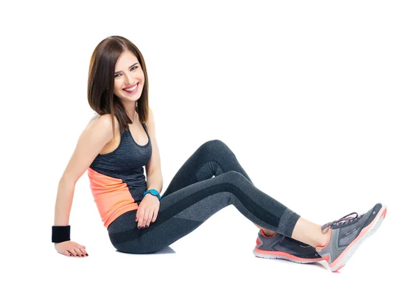 Cheerful sporty woman sitting on the floor — Stock Photo, Image