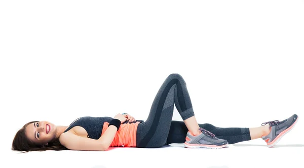 Cheerful sporty woman lying on the floor — Stock Photo, Image