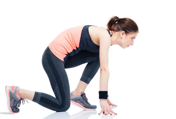 Sportliche Läuferin in Startposition — Stockfoto