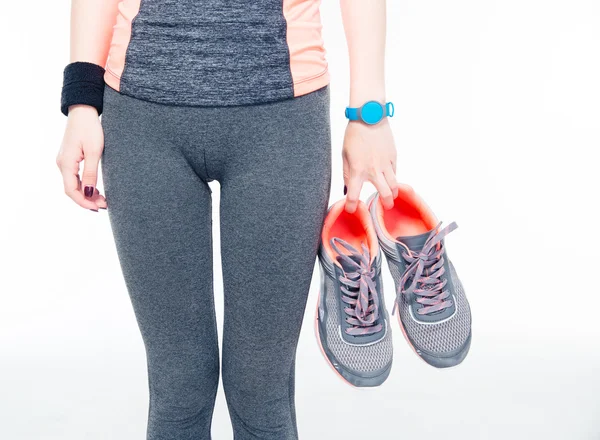 Womans hands holding sneakers — Stock Photo, Image