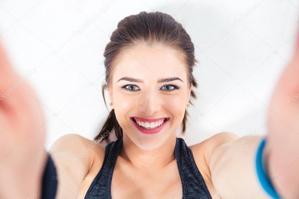 Smiling cute woman making selfie photo