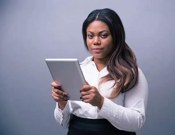 Serious businesswoman standing with tablet computer — Stock Photo, Image