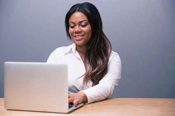 Happy businesswoman using laptop — Stock Photo, Image