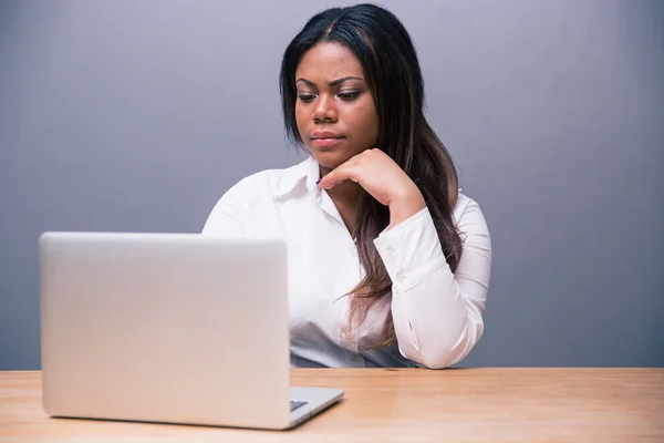 Thoughtful businesswoman using laptop — Stock Photo, Image