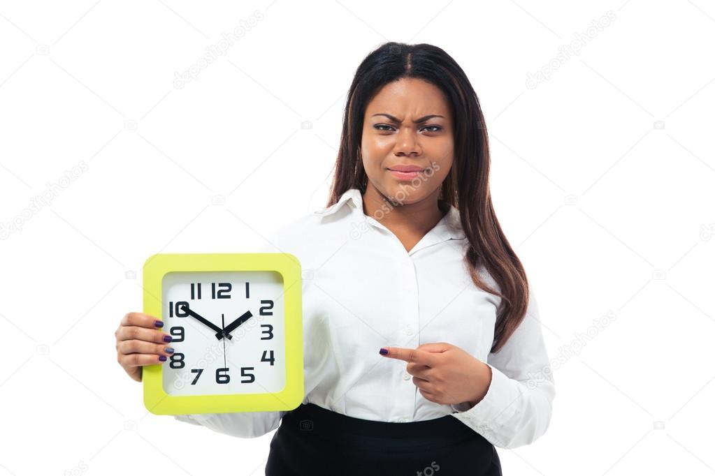 Dissatisfied businesswoman pointing finger on the clock